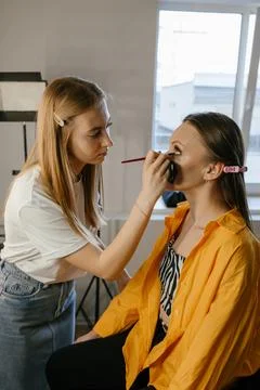 Makeup Artist Applying Foundation to Client in Salon Stock Photos