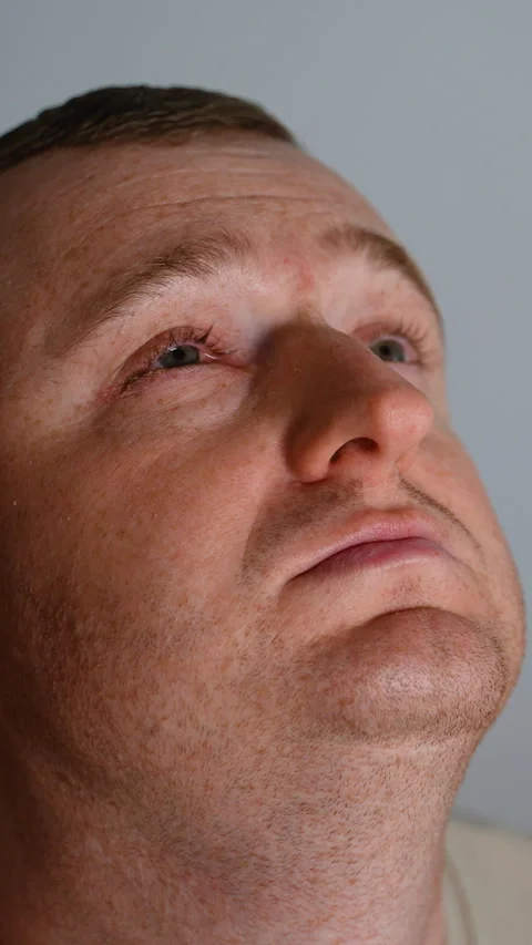 Makeup artist applying foundation on a mans face in studio Stock Footage 317722447