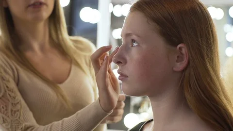 Makeup artist applying make-up on face of model Stock Footage 99482172