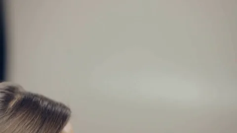 Makeup artist applying makeup on eyelashes. Vertical Panning Stock Footage 72142893