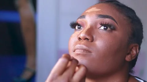Makeup artist applying makeup powder and paste on lady's face. Make up treatment Stock Footage 217876688