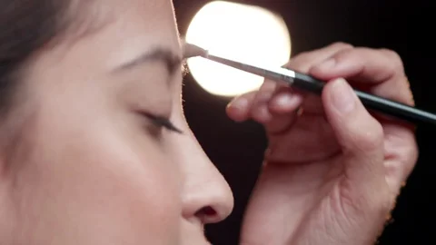 Makeup Artist applying Makeup to womans face. Stock Footage 90739421