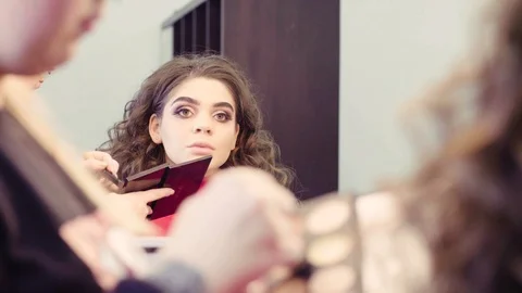 The makeup artist applying powder on the face Stock Footage 88556023