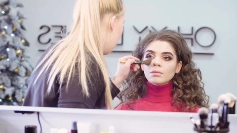 The makeup artist applying powder on the face 스톡 동영상 88556216