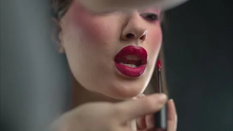 Makeup Artist Applying Red Lipstick to a Beautiful Womans Lips in a Glamorous Stock Footage 314523213