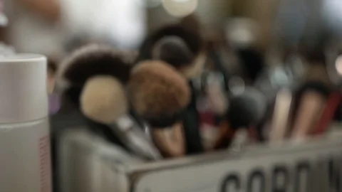 Makeup artist brushes in a box on a table near the mirror Stock Footage 129260414