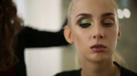 The makeup artist checks the final result Stock Footage 68026970