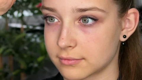 Makeup artist checks the placement and quality of applied false eyelashes on a Stock Footage 346021078