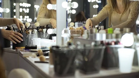 Makeup artist chooses makeup brush Stock Footage 99482138