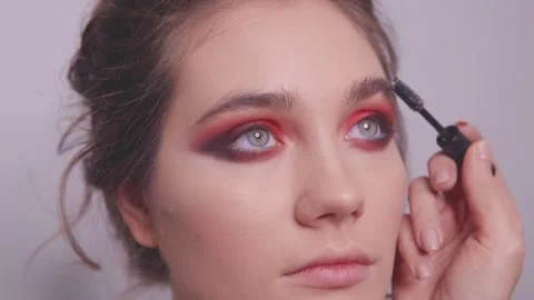 The makeup artist combs the model's eyebrows Stock Footage 142201431