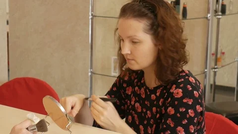 Makeup artist conducts a master class for young girl. Stock Footage 72622978
