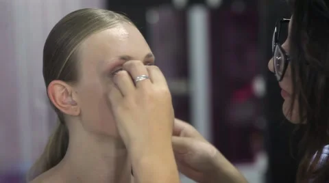 Makeup artist contouring model's face using makeup Stock Footage 67319245