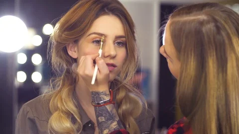 The makeup artist correcting the shape of eyebrow Video stock 88730695