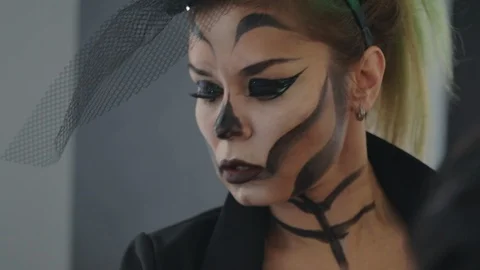Makeup artist creates make-up on the face, preparing for the halloween party Stock Footage 117704791