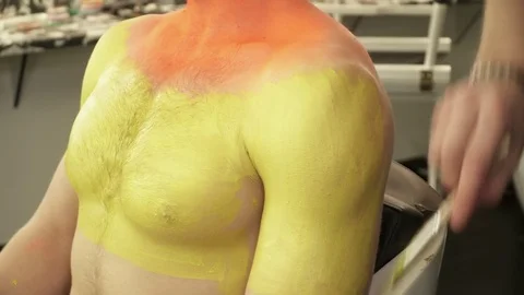 Makeup artist creating art makeup for a man Stock Footage 73540162