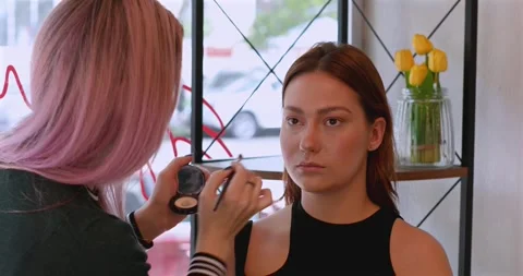 Makeup artist doing professional make up of young woman. Stock Footage 311218475