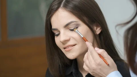 Makeup artist doing professional makeup in a beauty studio Stock Footage 129167946