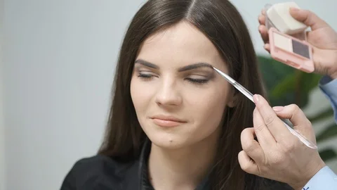 Makeup artist doing professional makeup in a beauty studio Stock Footage 129169203