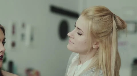Makeup artist finished work and straightens hair model Stock-Footage 68059411