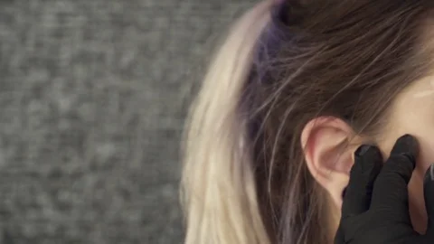 Makeup artist fixing the shape of brows Stock Footage 73673337