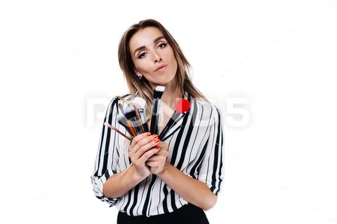 Makeup artist girl on a white background with brushes Stock Photos