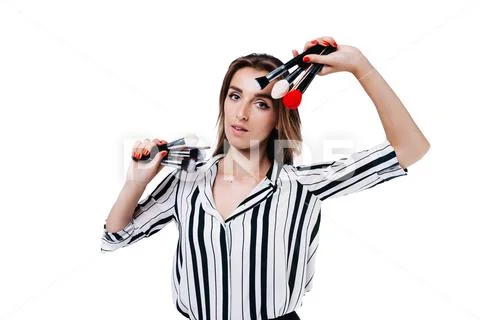 Makeup artist girl on a white background with brushes Stock Photos