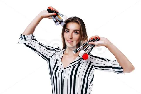 Makeup artist girl on a white background with brushes Stock Photos