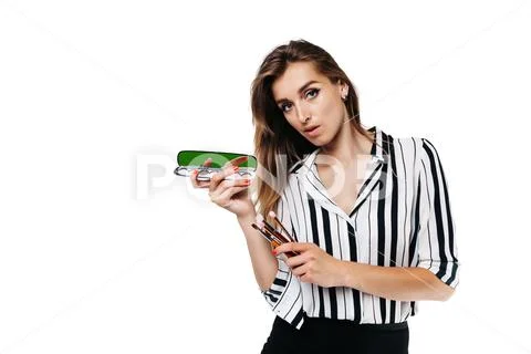 Makeup artist girl on a white background with brushes Stock Photos