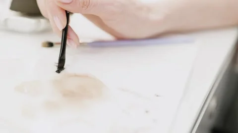 Makeup artist hand with brush applying makeup. Close-up Video stock 317084312