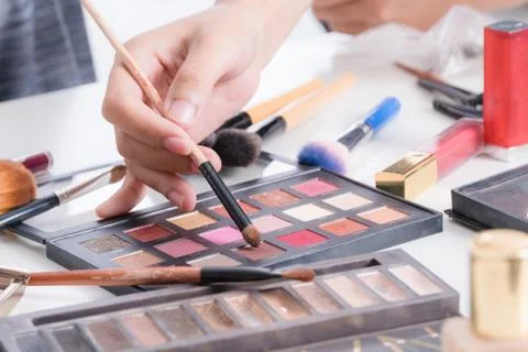 Makeup artist hand using brushes powder foundation and tools of make up artist Stock Photos