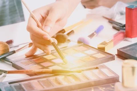 Makeup artist hand using brushes powder foundation and tools of make up artist Stock Photos