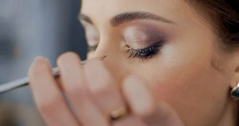Makeup artist imposes false eyelashes to model in beauty salon Stock Footage 126184214