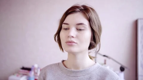 Makeup artist looks at the model's face Stock Footage 82457584