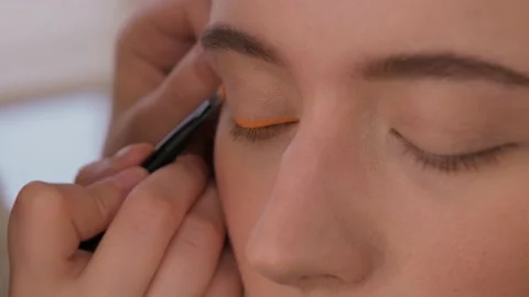 Makeup artist makes arrows model. Close-up. Stock Footage 199839292