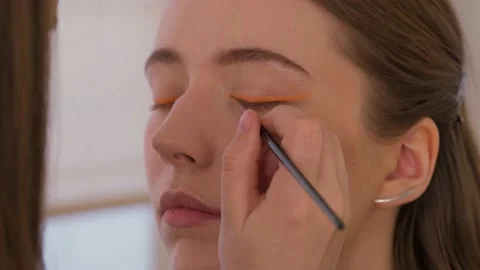 Makeup artist makes arrows model. Close-up. Stock Footage 199839321