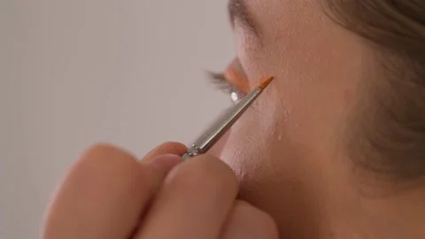 Makeup artist makes arrows model. Close-up. Video stock 199839344