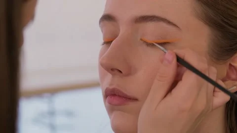 Makeup artist makes arrows model. Close-up. Stock Footage 199839347