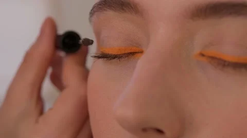 Makeup artist makes arrows model. Close-up. Stock Footage 199839370
