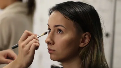 Makeup artist makes beautiful makeup model Stock Footage 68737352