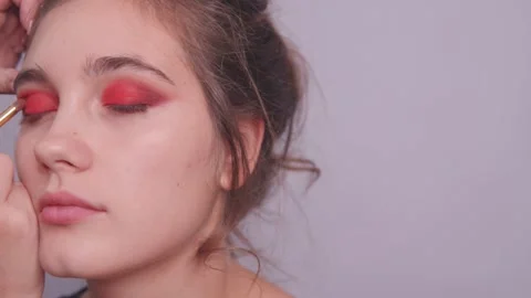 Makeup artist makes bright eye makeup of the model Stock Footage 142201229