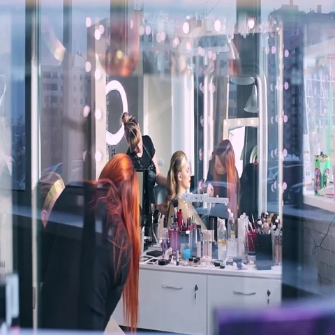 Makeup artist makes models eye makeup. Hairdresser makes hairstyle for model Stock Footage 69546839