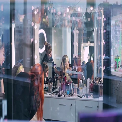 Makeup artist makes models eye makeup. Hairdresser makes hairstyle for model Stock Footage 69546939