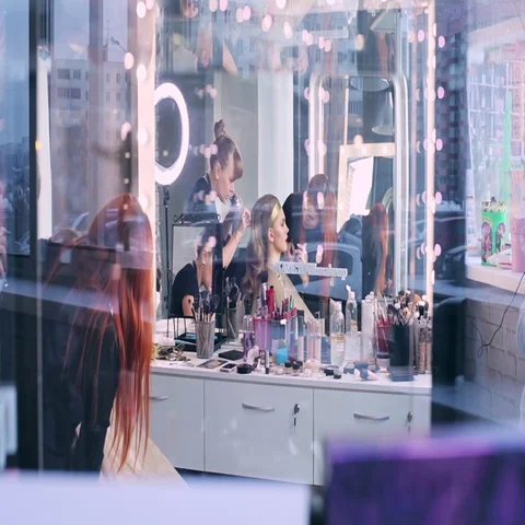 Makeup artist makes models eye makeup. Hairdresser makes hairstyle for model Stock Footage 69547126