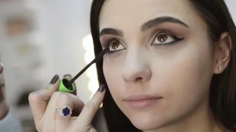 Makeup artist makes models eye makeup close up, slow motion Stock Footage 70663038