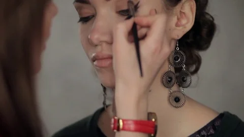 Makeup artist makes models eye makeup Stock Footage 73578472