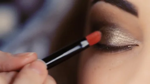 Makeup artist makes models eye makeup Stock Footage 83409638