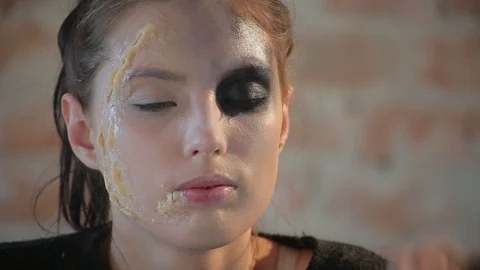 Makeup artist makes wax plastic makeup for art cinema and paints face of girl Stock Footage 105599789