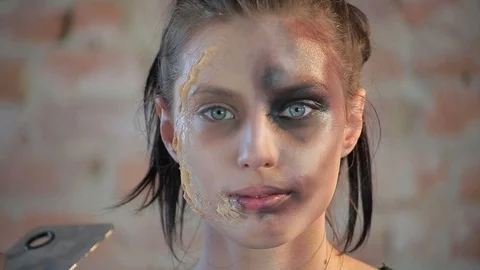 Makeup artist makes wax plastic makeup for art cinema and paints face of girl Stock Footage 105599845