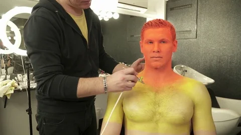 Makeup artist making creative makeup for a man Stock Footage