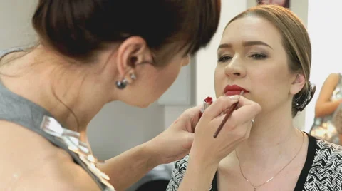 Makeup artist making make-up for stylish model Stock Footage 63499675